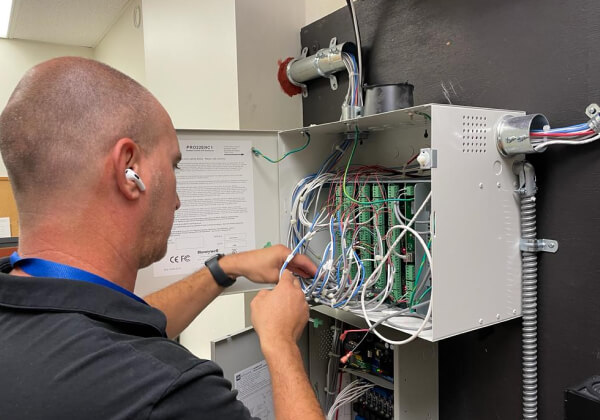 Licensed TXP Security technician servicing an access control panel