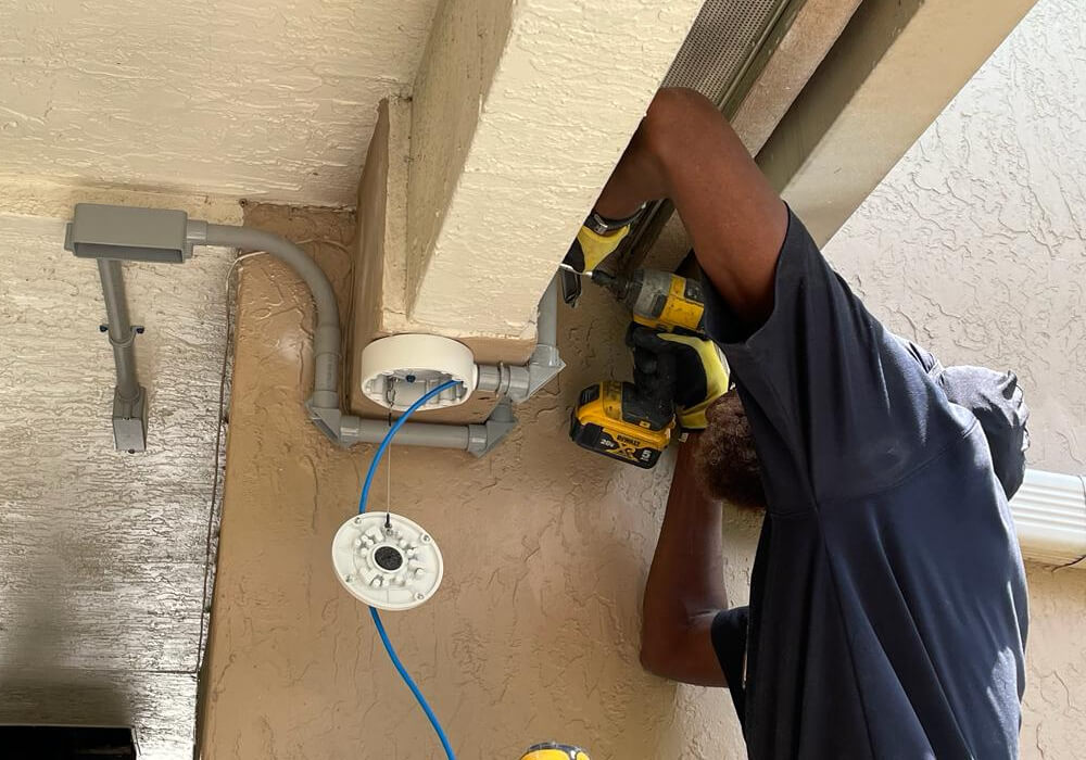 Technician installing commercial security camera in Dallas
