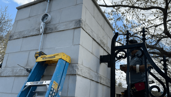 Technician installing residential security at Dallas community gate