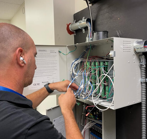 Technician working on a school access control panel