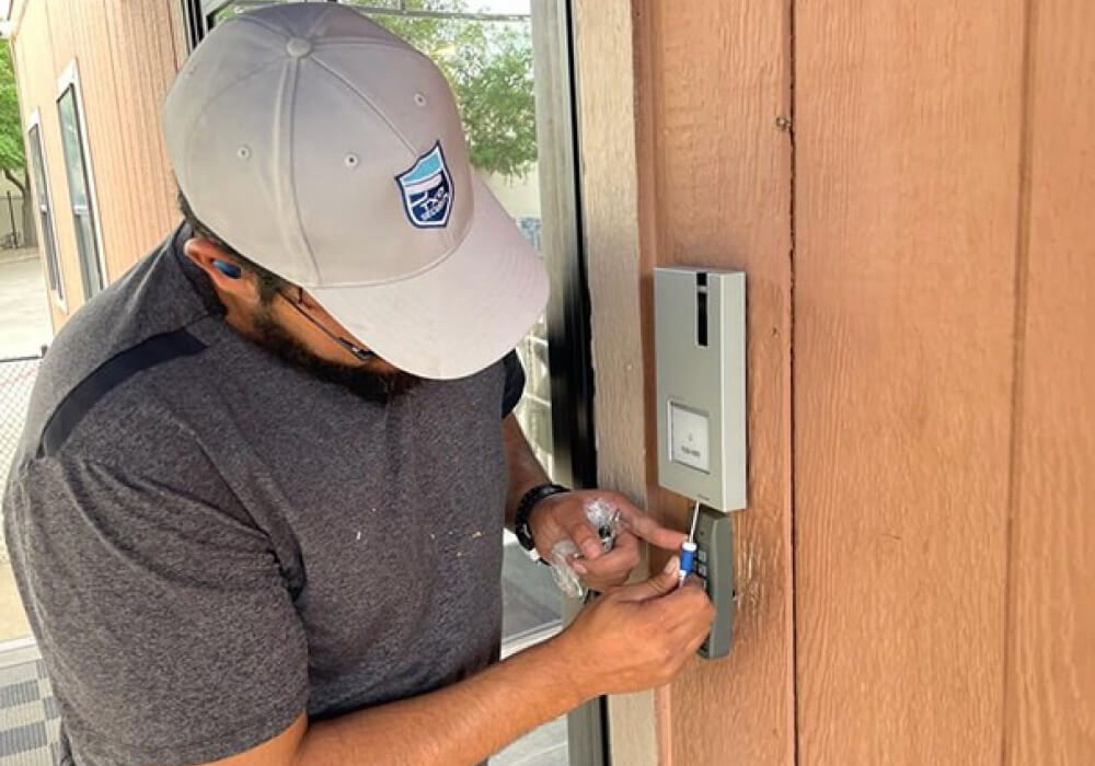 TXP technician installing access control keypad at Dallas business