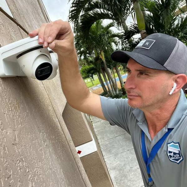 TXP Security technician installing security cameras