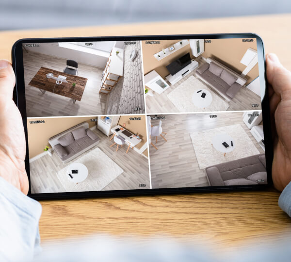 Multiple security camera feeds viewed on a tablet screen