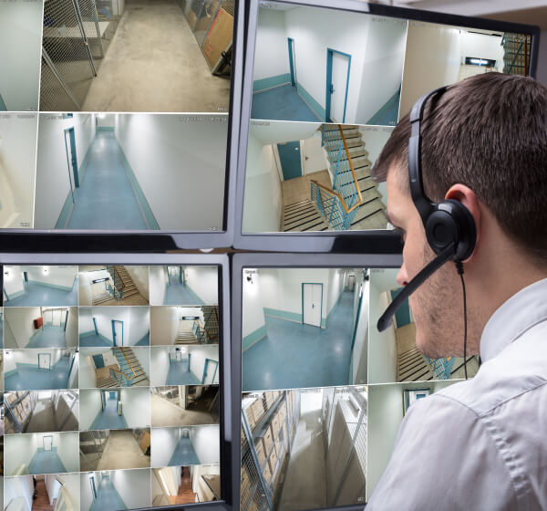 Operator reviewing live video monitoring feeds at a central station