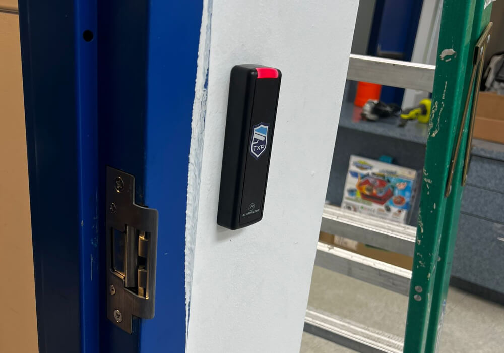 Card reader and electric strike installed on a commercial interior door