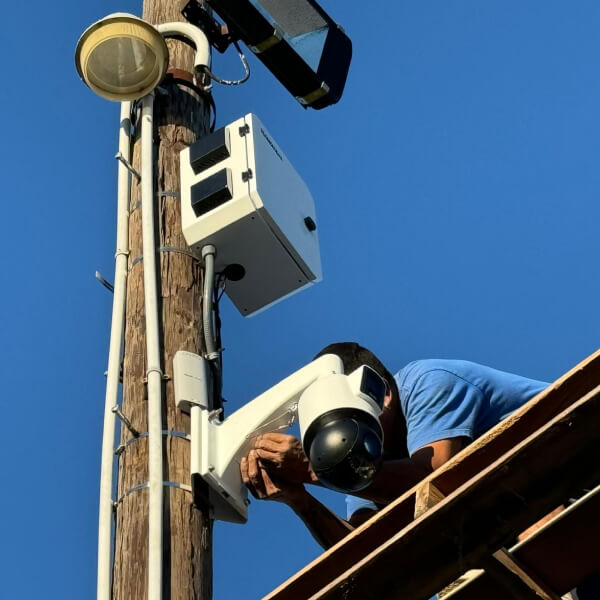 Technician installing a security camera tied to Waco access control