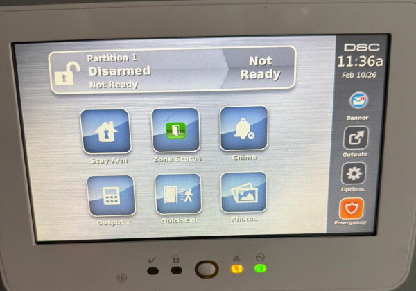 Touchscreen keypad showing partition status on a commercial alarm system